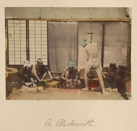 A nineteenth-century photograph of Japanese blacksmiths at work in a forge