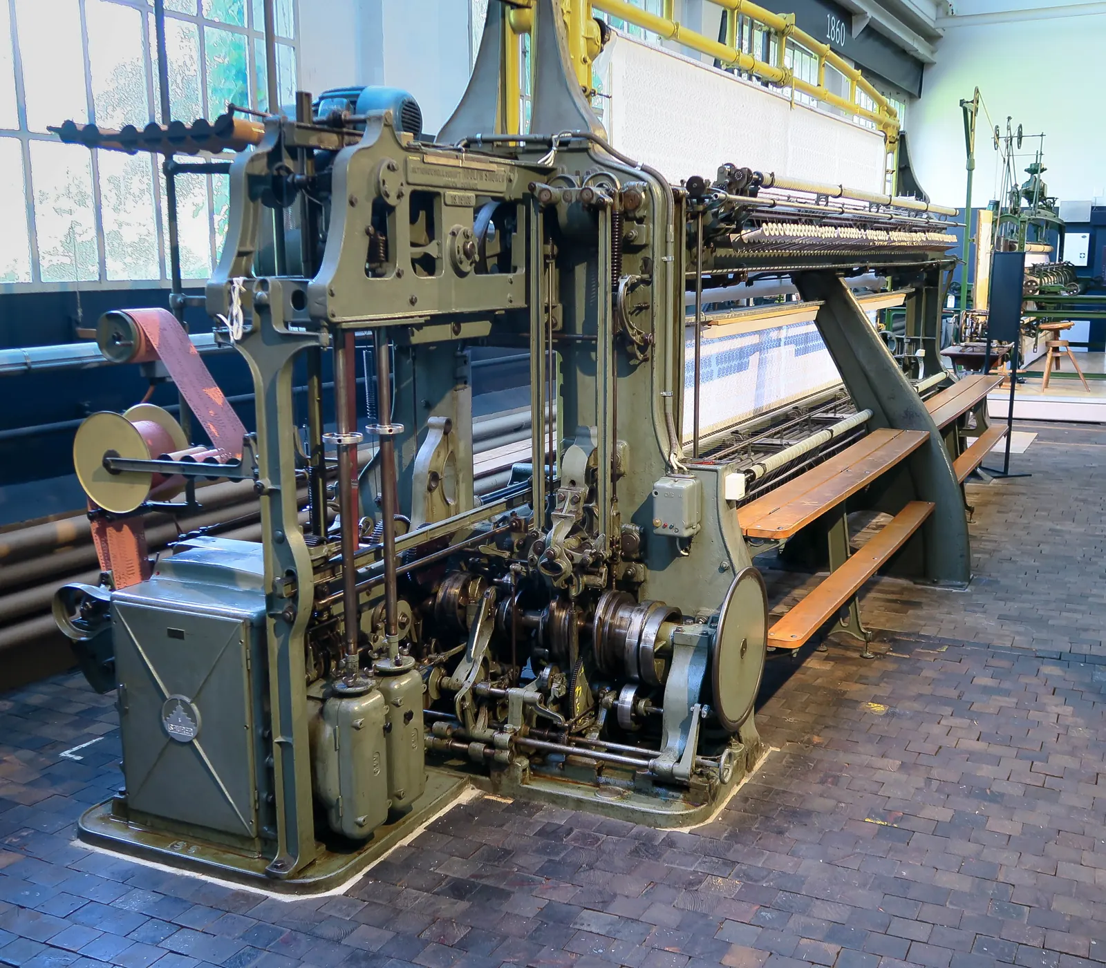An industrial embroidery machine in a textile workshop