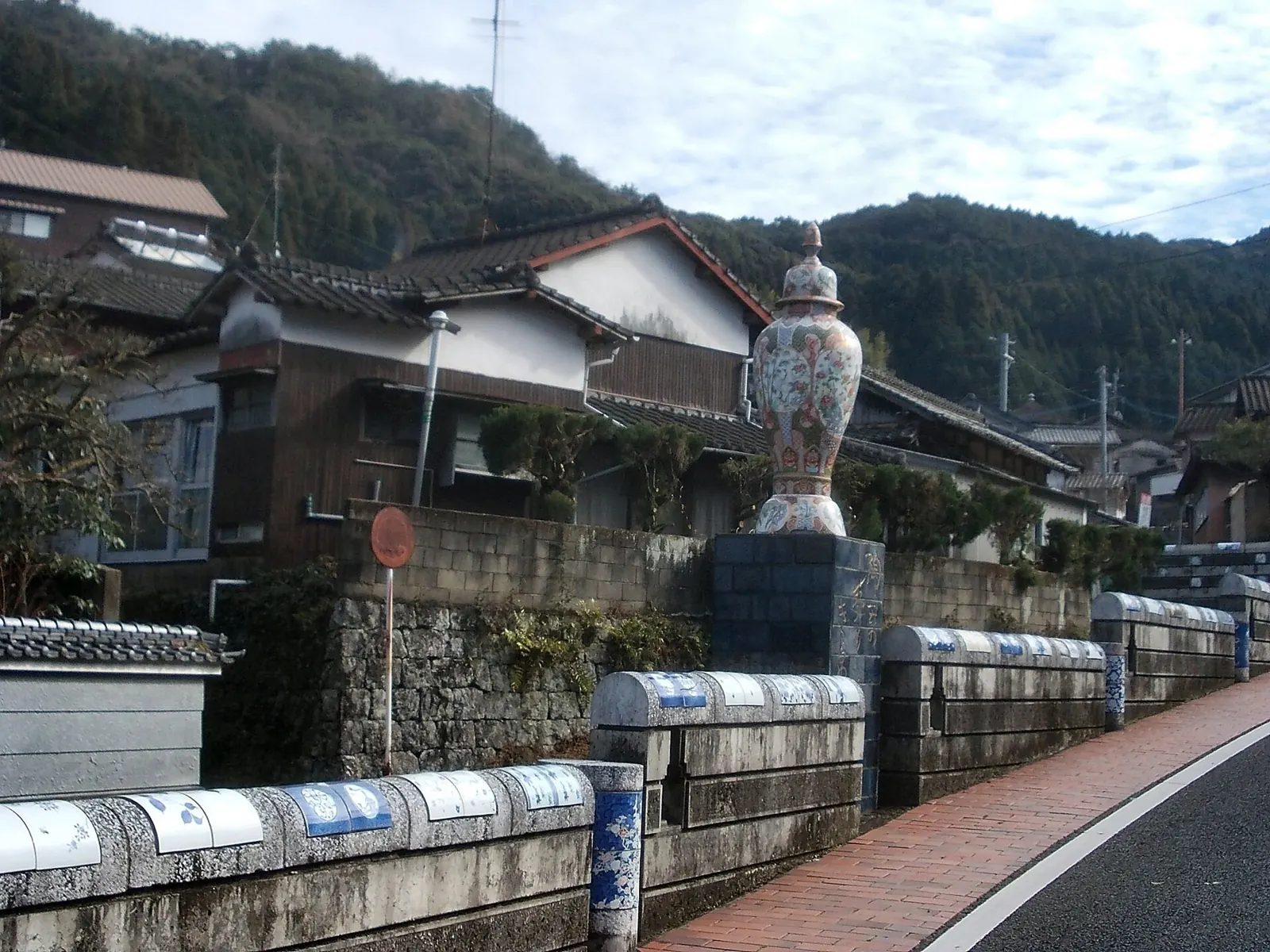 A street in Hasami, Nagasaki, with a large porcelain vase and blue-and-white tiled wall