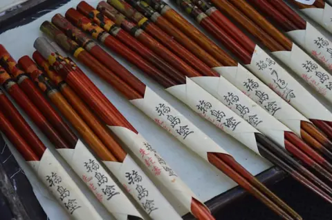 Wajima lacquerware chopsticks in paper sleeves