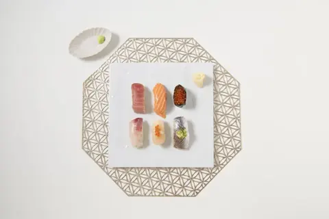 A Japanese ceramic serving plate with sushi, photographed from above