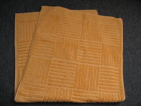 Folded terry towels with a woven pattern